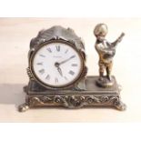A vintage cast metal figural clock, length 13.5cm.