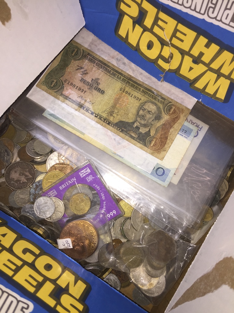 A box of world coins and bank notes