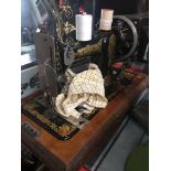 A Jones hand cranked sewing machine with case and key
