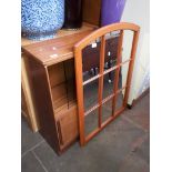 A teak bookcase and a mirror.