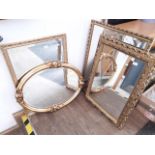 Four large modern gold framed mirrors.