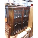 A 1930s glazed oak cabinet.