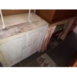 An old painted cupboard and a vintage dressing table with curtains...