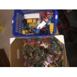 A box of army figures and a basket of diecast vehicles