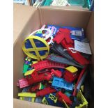 A box of childrens toy train track and other toys