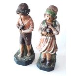 A pair of plaster figures depicting a boy and a girl, height 48c,m.