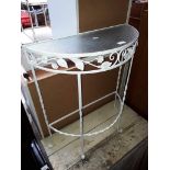 A wrought metal console table.