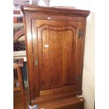 A Georgian cross banded oak corner cabinet.