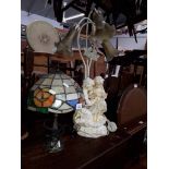 A Tiffany style lamp and a figural lamp.