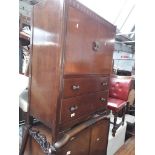 An oak chest of drawers and a similar wardrobe.