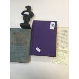 A cast iron figure depicting the anglican minister Joshua Brooke (1754-1821) and two books: The