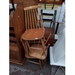 A set of three retro light wood spindle back chairs.