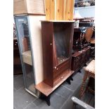 Three items of furniture comprising a copper top coffee table, a bookcase with glass sliding doors