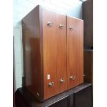 A teak chest of drawers.