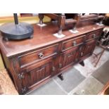 A Jaycee oak sideboard with linen fold panels, length 146cm.