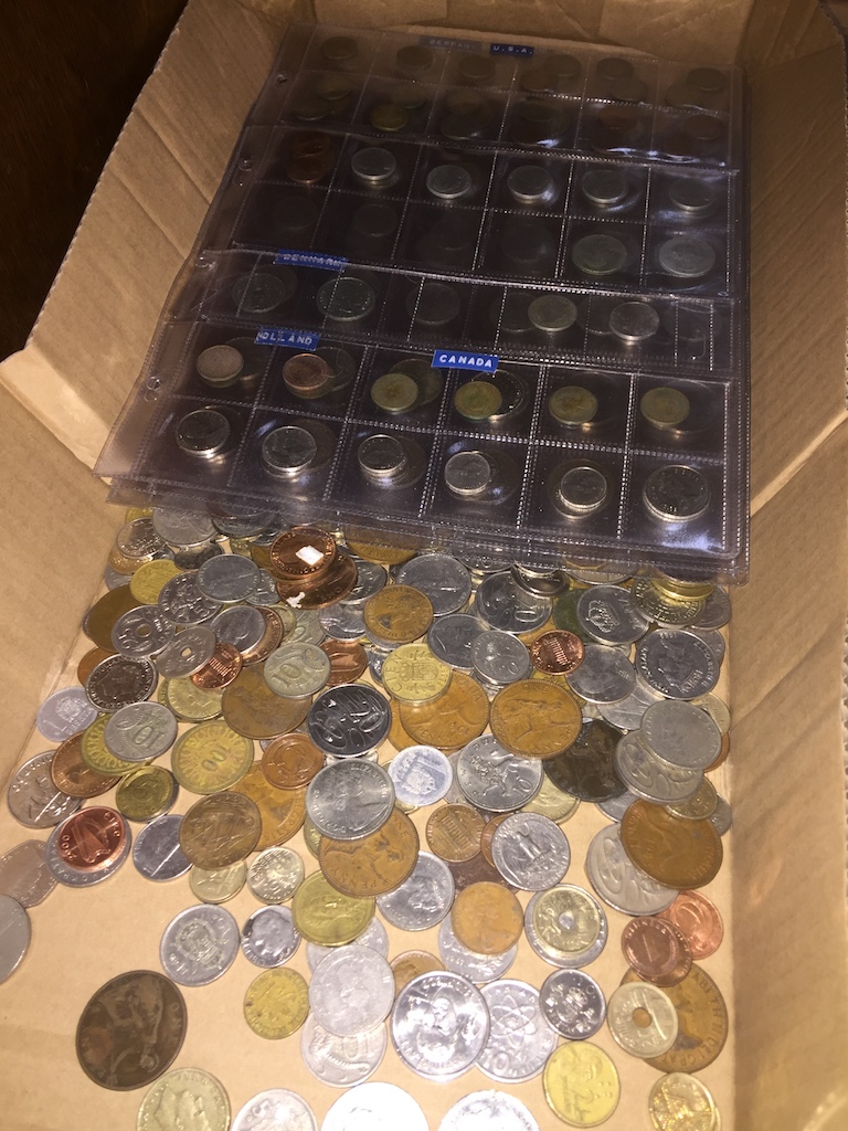 A collection of world coins including 8 plastic sheets