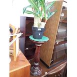 An artificial plant with hard wood plant stand.