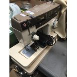 A Singer 7110 electric sewing machine with foot pedal