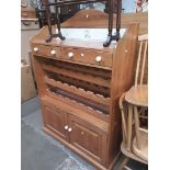 A pine kitchen cabinet with tile back, wine storage and lower cabinet.