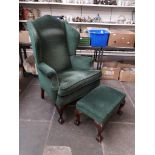 A Queen Anne style green upholstered wing back armchair with matching foot stool.