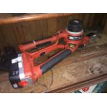 A Black and Decker Alligator cordless chain saw with charger