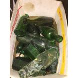 A box of old, mainly green bottles