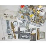 A tin of of assorted items including watches, badges, buttons, lighter, trench art etc.