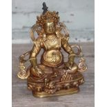 A Tibetan gilt bronze depicting the Jhambala god of wealth, height 21cm.