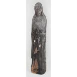 A religious wood carving depicting a monk praying, height 29cm.