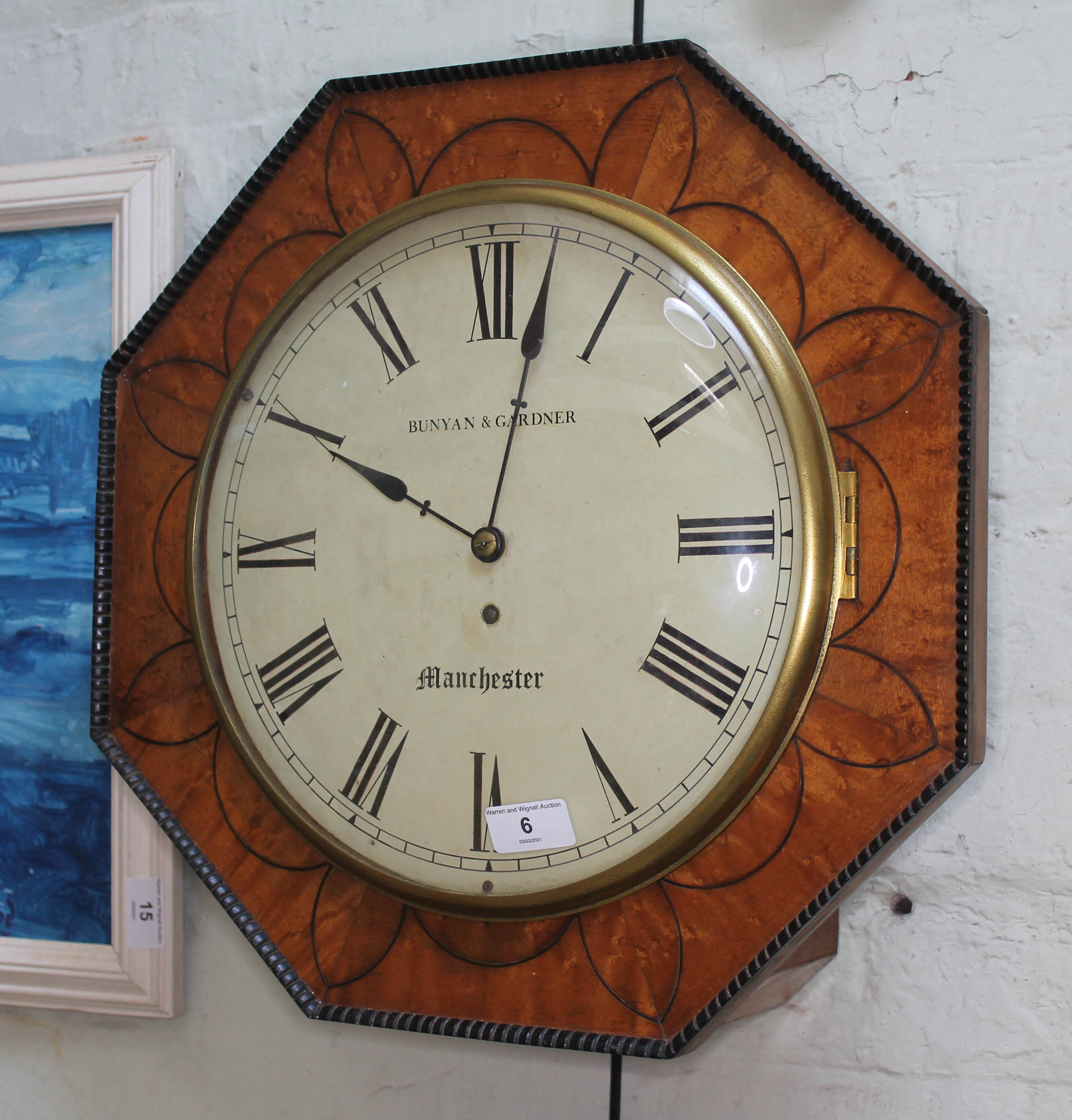 A 19th century bird's eye maple octagonal wall clock, the 12" dial painted with Roman Numerals and