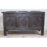 A 17th century carved and panelled joined oak coffer, length 107.5cm, depth 45cm & height 62cm.