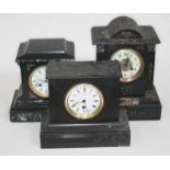 A group of three black slate/marble mantle clocks, height 21cm to 31cm.