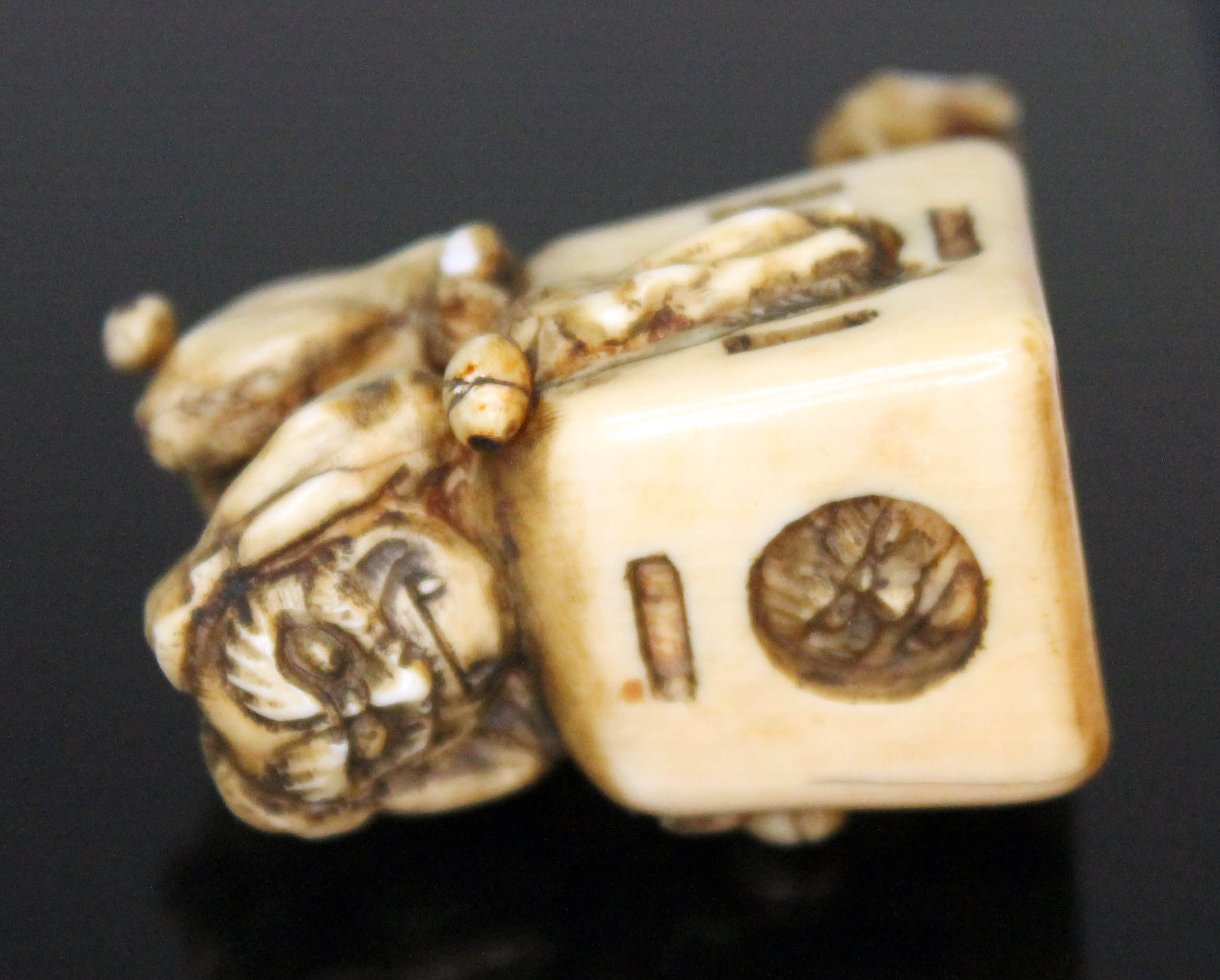 A Japanese carved ivory netsuke formed as an oni catcher on top of a box with protruding limbs, - Image 4 of 8