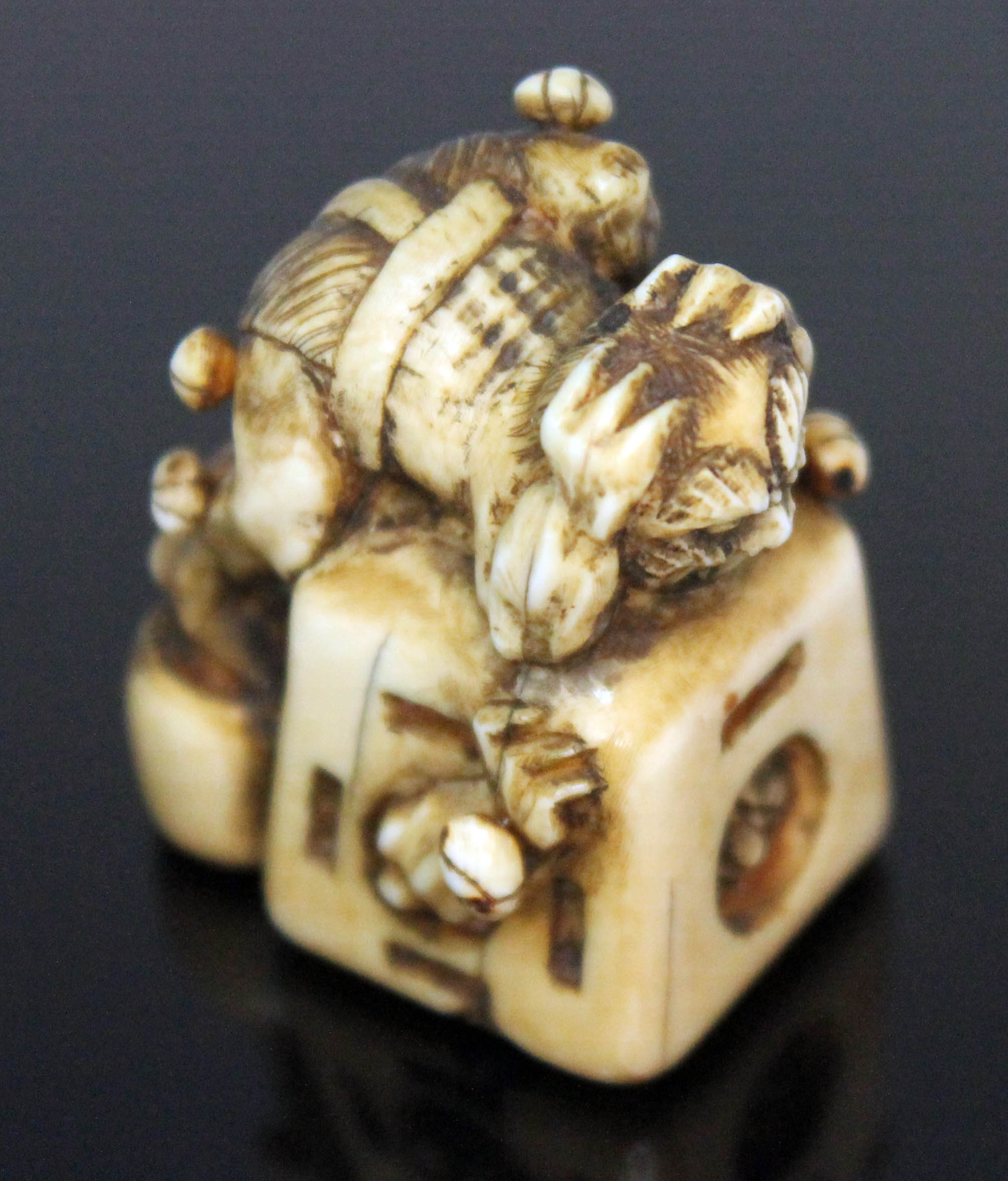 A Japanese carved ivory netsuke formed as an oni catcher on top of a box with protruding limbs, - Image 5 of 8