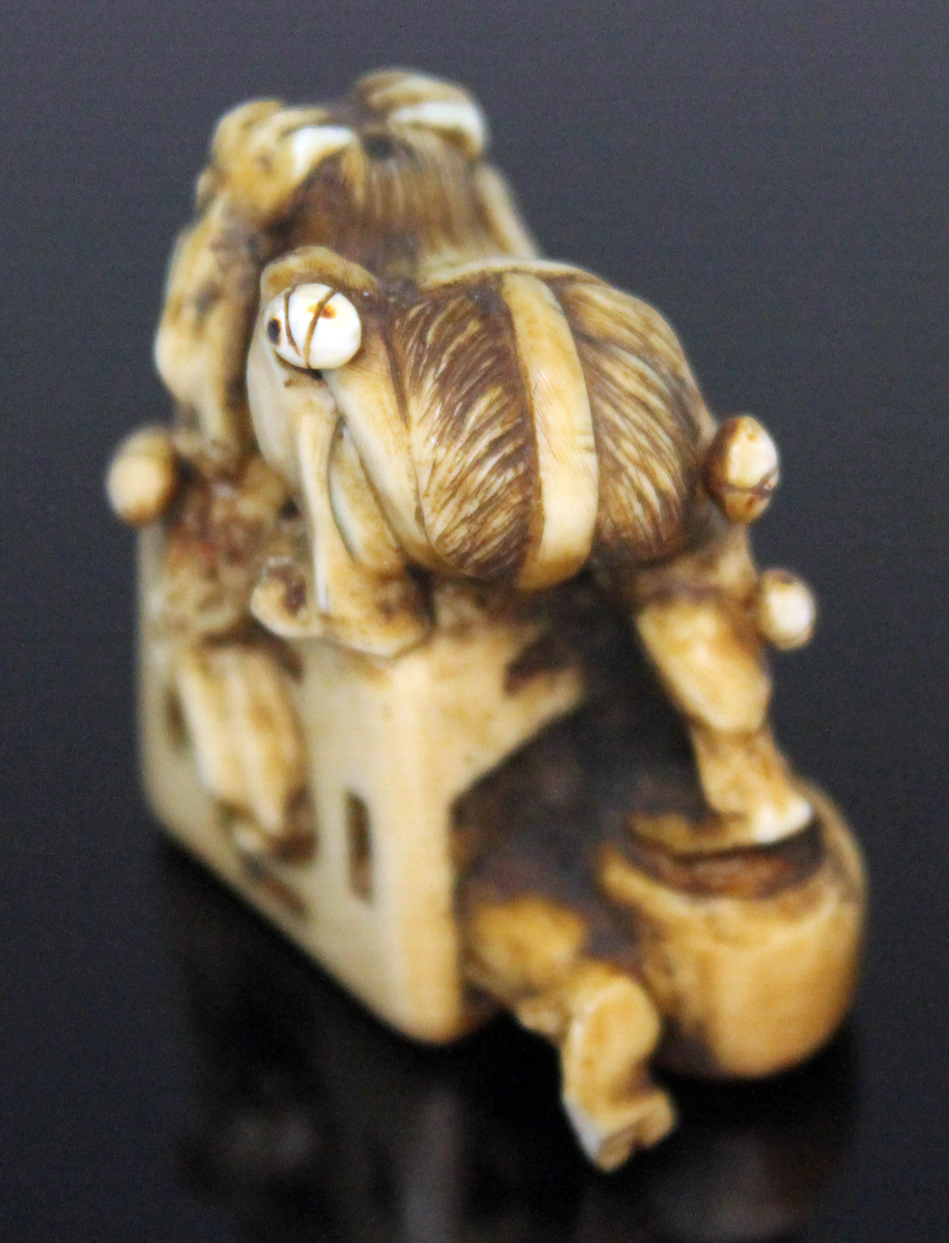 A Japanese carved ivory netsuke formed as an oni catcher on top of a box with protruding limbs, - Image 7 of 8