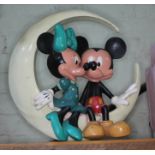 A vintage Disney ornament modelled as Micky & Minnie Mouse sat within a crescent moon, height 40cm.