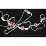 A pink sapphire and diamond set necklace, the three vivid pink sapphires weighing approx. 0.50
