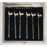 A cased set of six cocktail sticks with gilt cockerel finials, marked Sterling Silver.