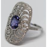 A sapphire and diamond cluster ring, the oval blue sapphire approx. 1ct, band marked '750', gross