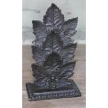 A Victorian cast metal letter rack or menu holder modelled as three maple leaves on weight base,