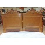 A continental birds eye maple double bed circa 1900, the heads with carved scrolls, with super
