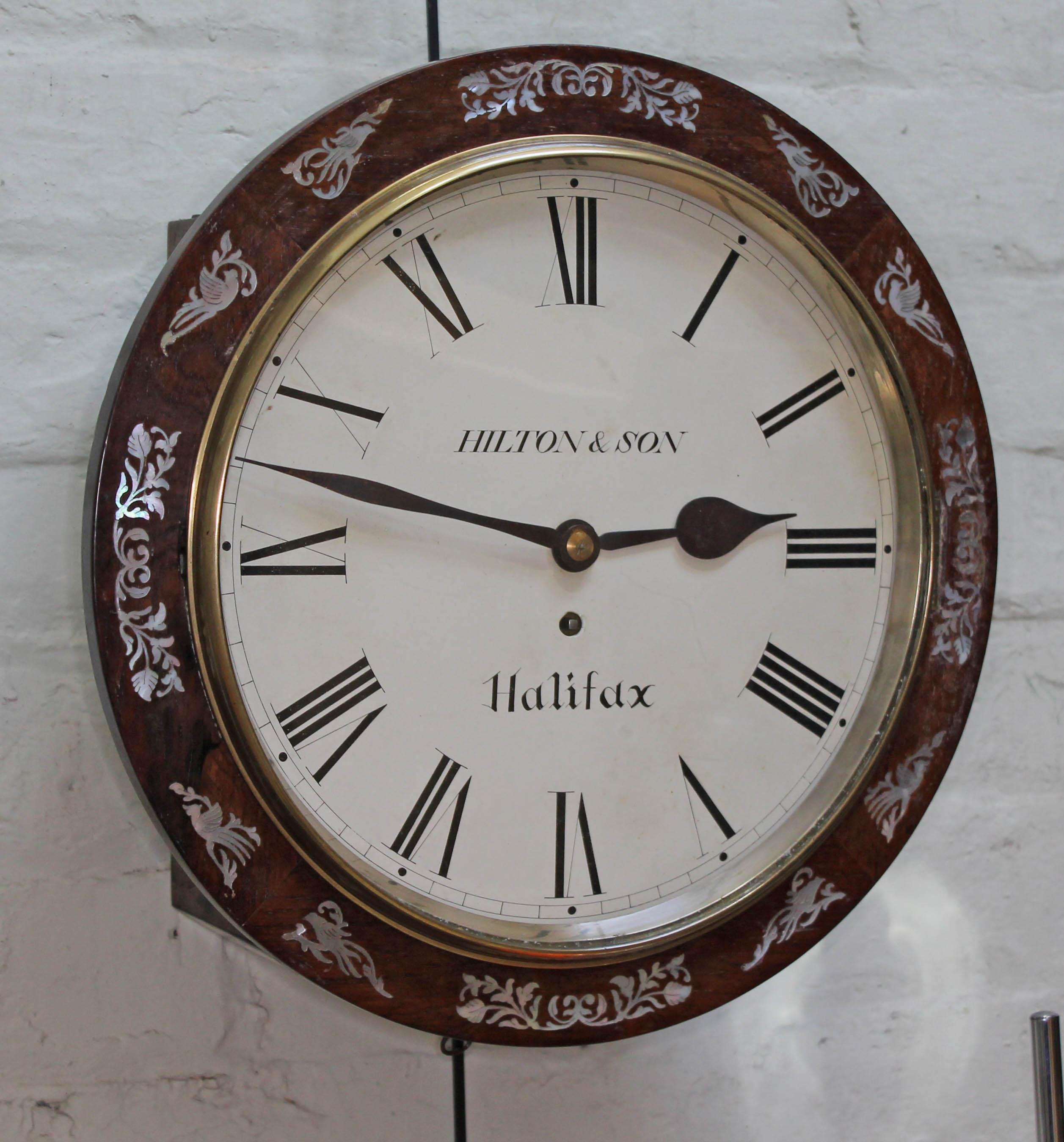 An early 19th century mother of pearl inlaid rosewood wall clock, the 12" dial painted with Roman