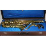 A brass tenor saxophone with hard case.