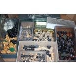 A box of various chess sets and games including one weighted.