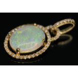 A precious opal and diamond pendant, the cnetral cabochon measuring approx. 12mm x 10mm x 2mm,
