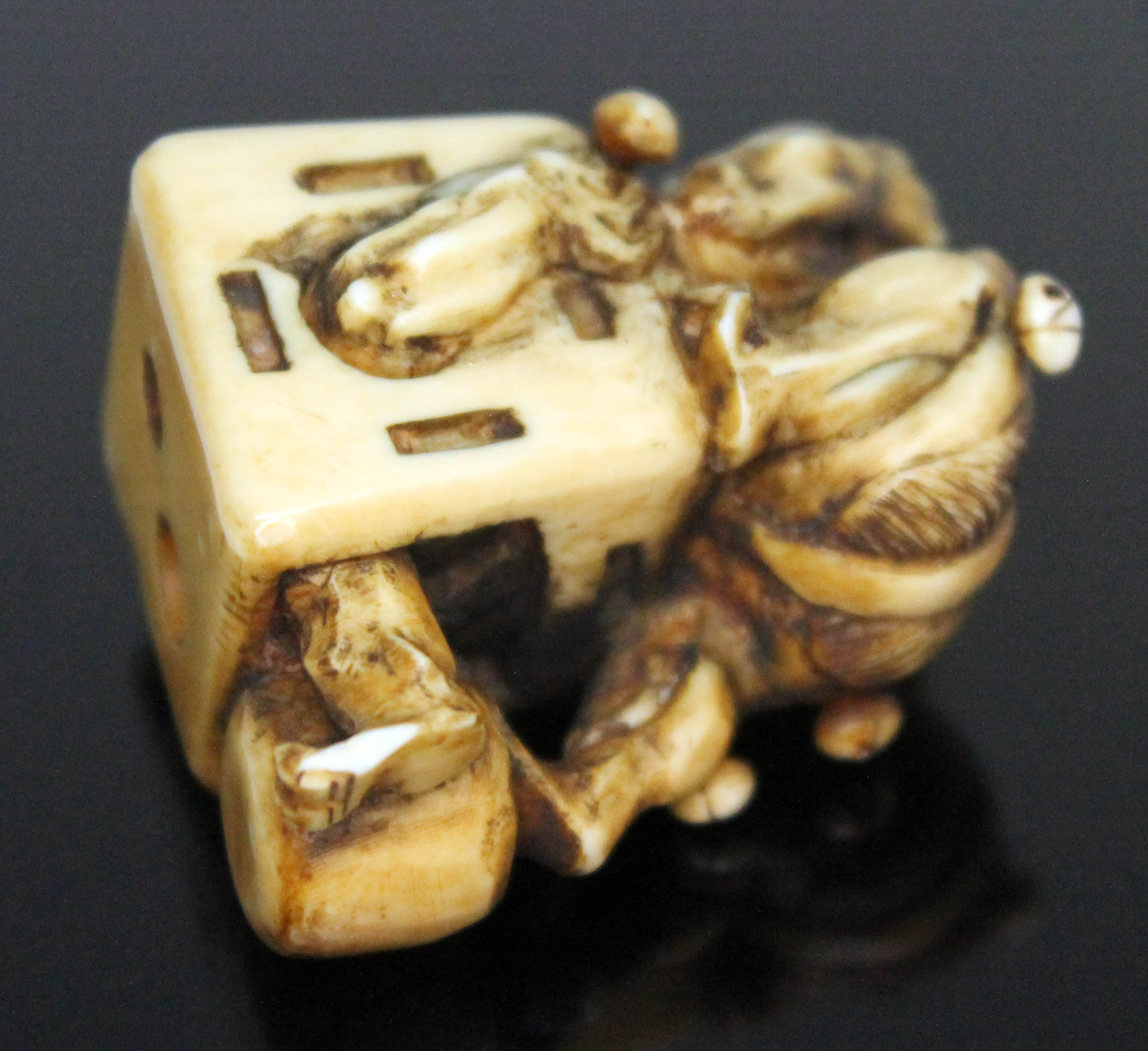 A Japanese carved ivory netsuke formed as an oni catcher on top of a box with protruding limbs, - Image 2 of 8
