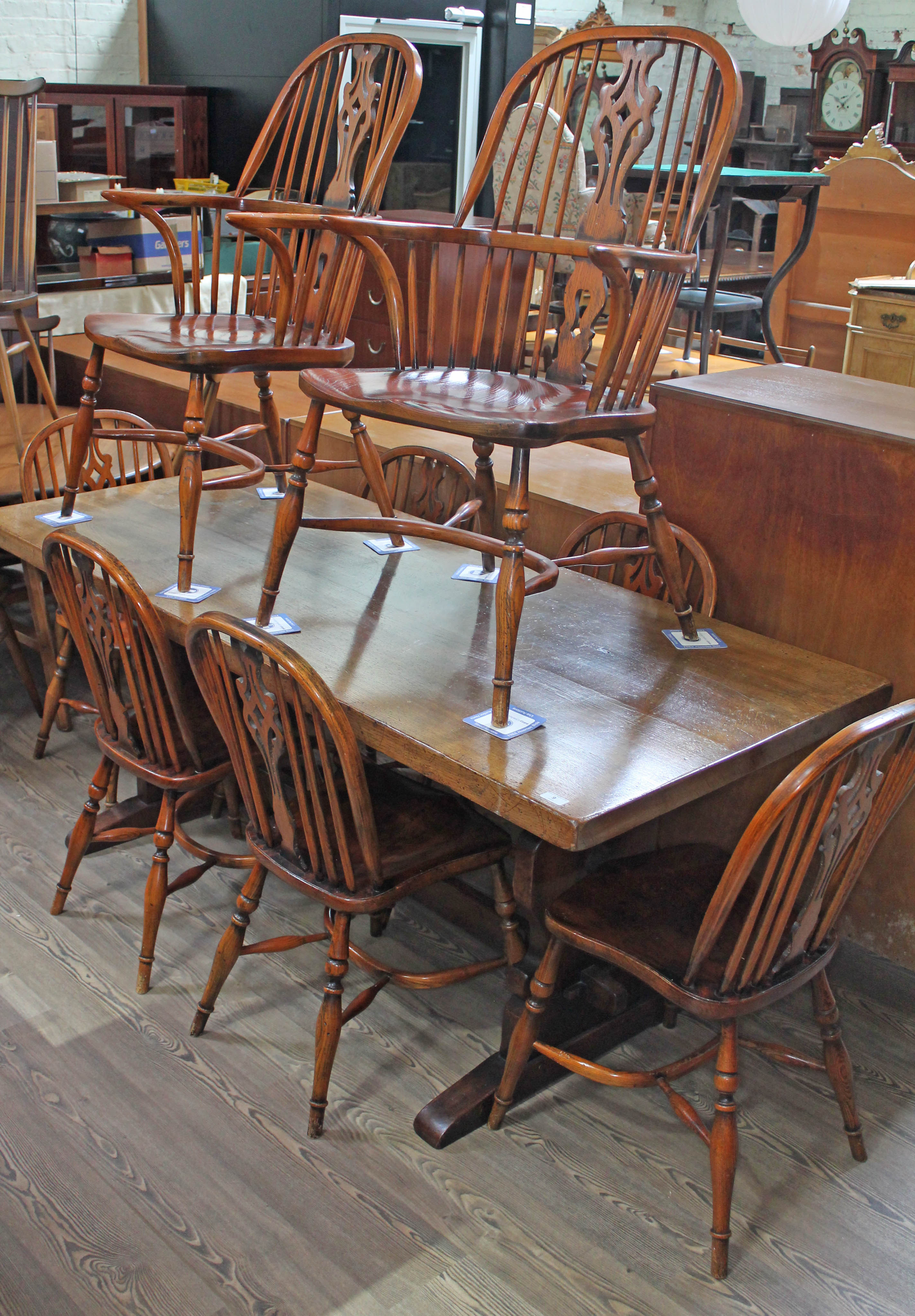 A Batheaston reproduction oak refectory table with eight ash and elm seated chairs comprising a