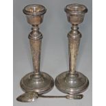 A pair of hallmarked silver candlesticks height 18.5cm and a silver teaspoon.