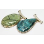 Two eastern pendants, one set with a tourmaline included quartz cabochon and the other a pear shaped