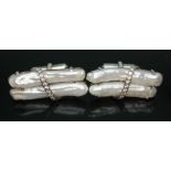 A pair of elongated pearl and diamond cufflinks, length 39mm each, crafted in white metal, unmarked,